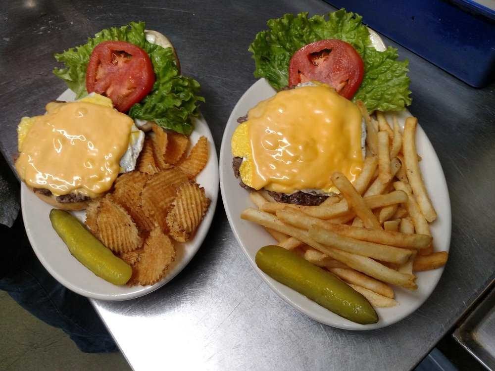 Two cheeseburgers with fries and waffle chips